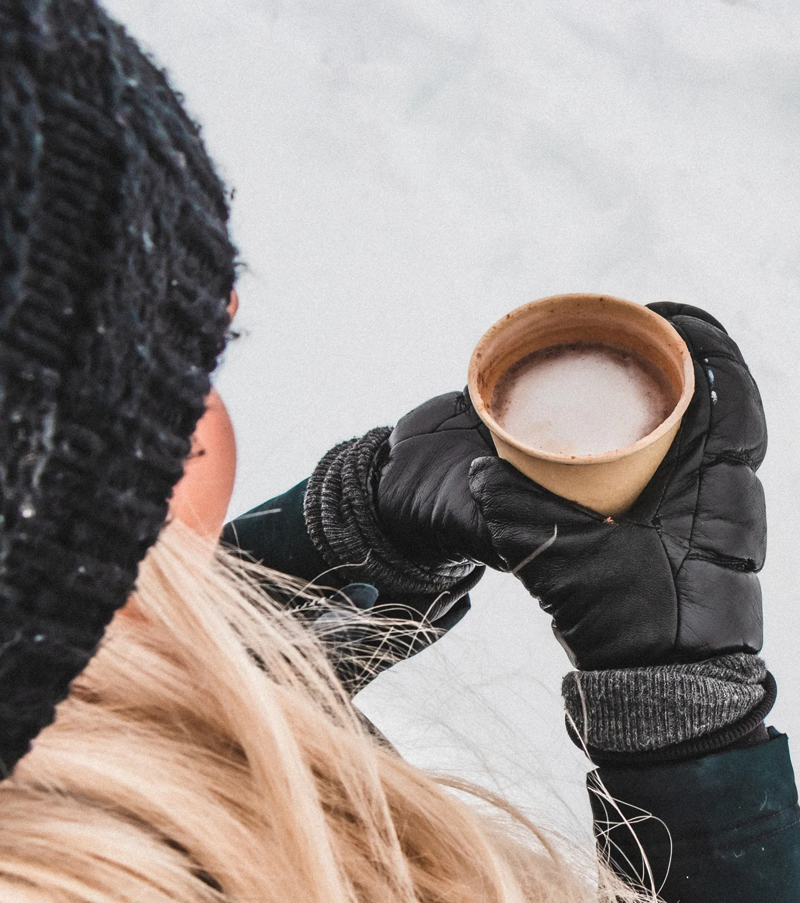 Woman holding a hot breverage in winter